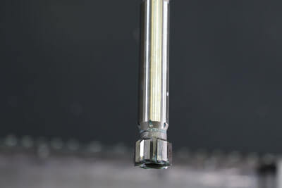 Image of reamer descending in vertical machining center.